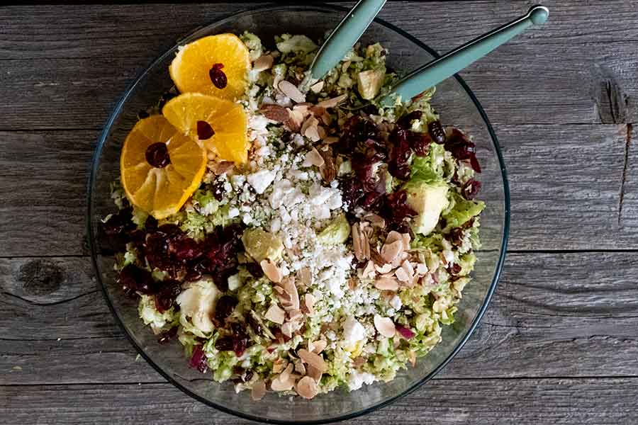 a bowl shredded Brussel sprout salad with cranberries & oranges for fall 