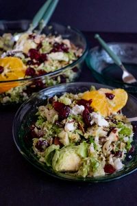 shredded brussels sprout salad with cranberries in a bowl
