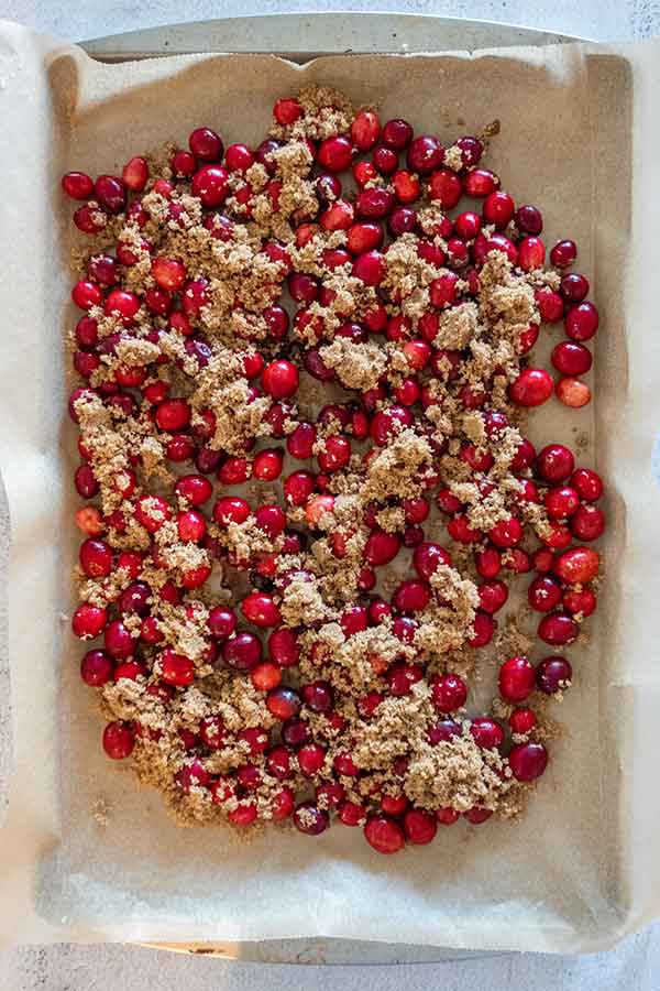 fresh cranberries topped with sugar on a baking sheet