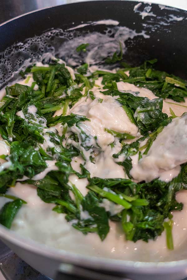 making lasagna spinach filling in a bowl