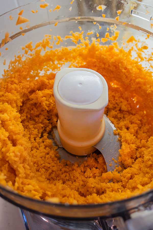 grated sweet potato and carrots in a food processor
