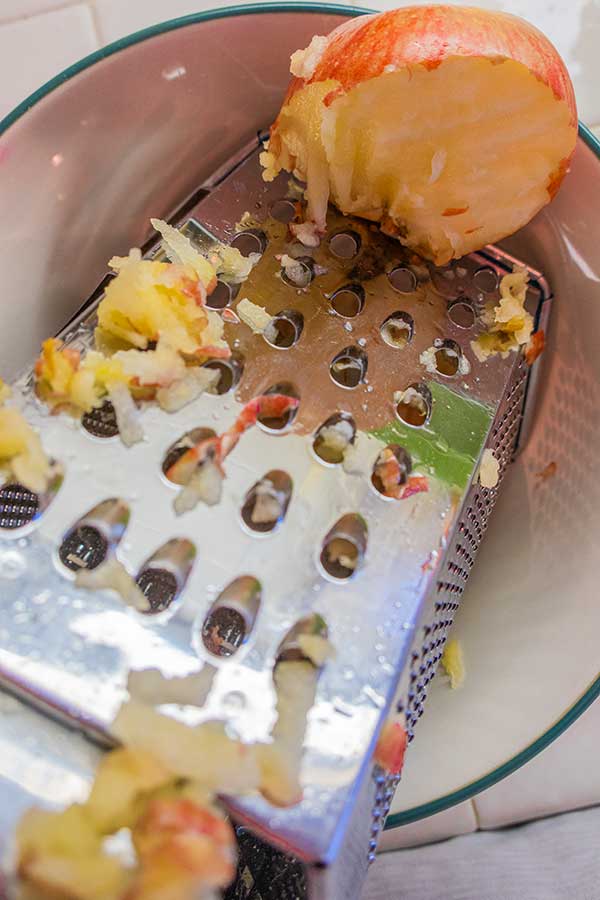 grating apples in a bowl