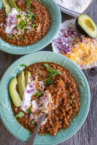 vegetarian lentil chilli with toppings in a bowl