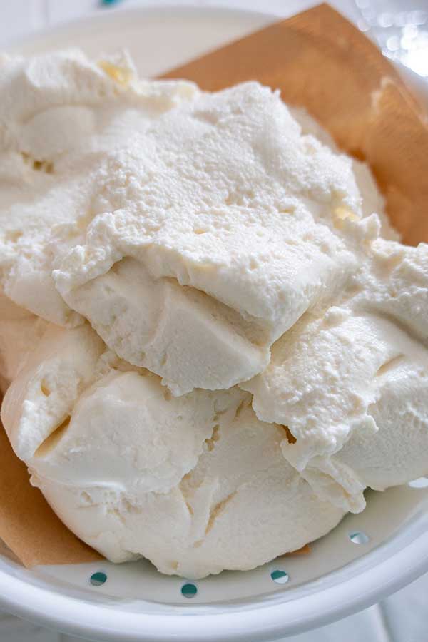 ricotta in a strainer lined with coffee filter