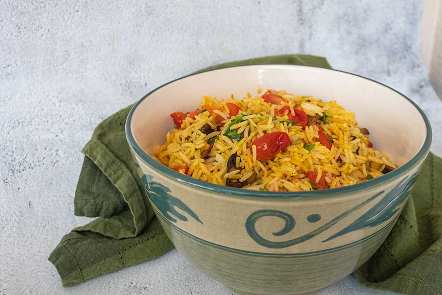 spiced rice with tomatoes and peppers in a bowl