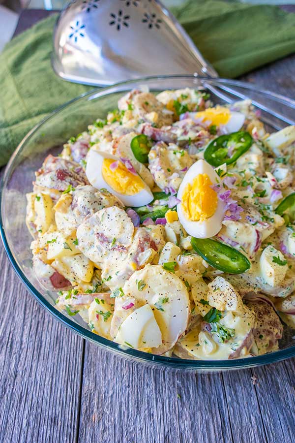 texas potato salad topped with eggs in a bowl