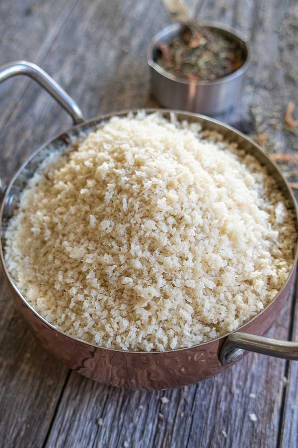 gluten-free breadcrumbs with herbs in the background