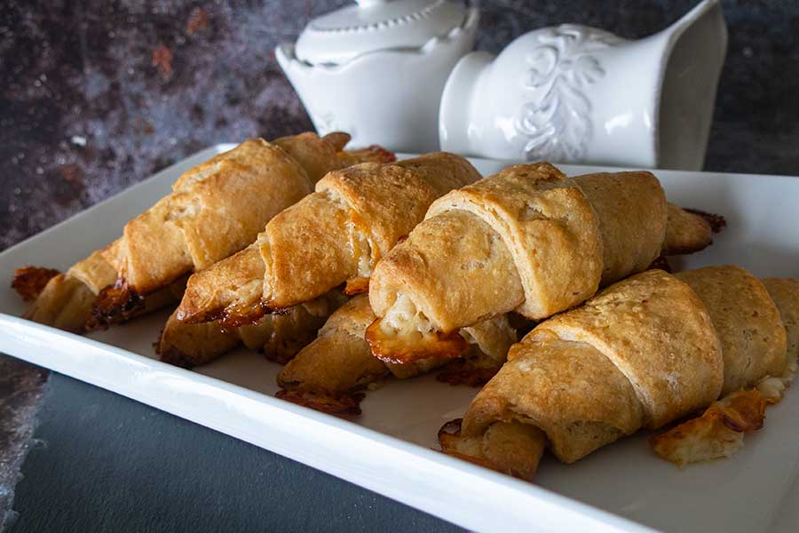 4 cheesy crescent rolls on a white tray