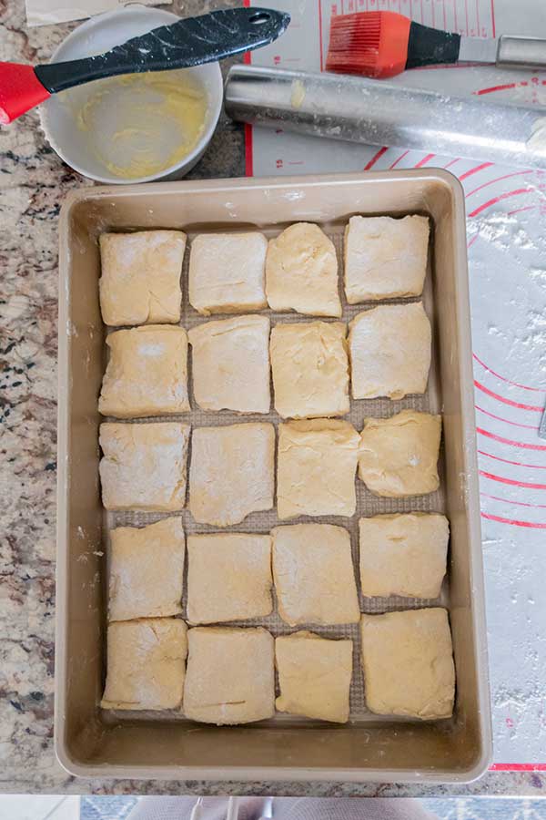 unbaked shaped Parker house rolls in a baking pan