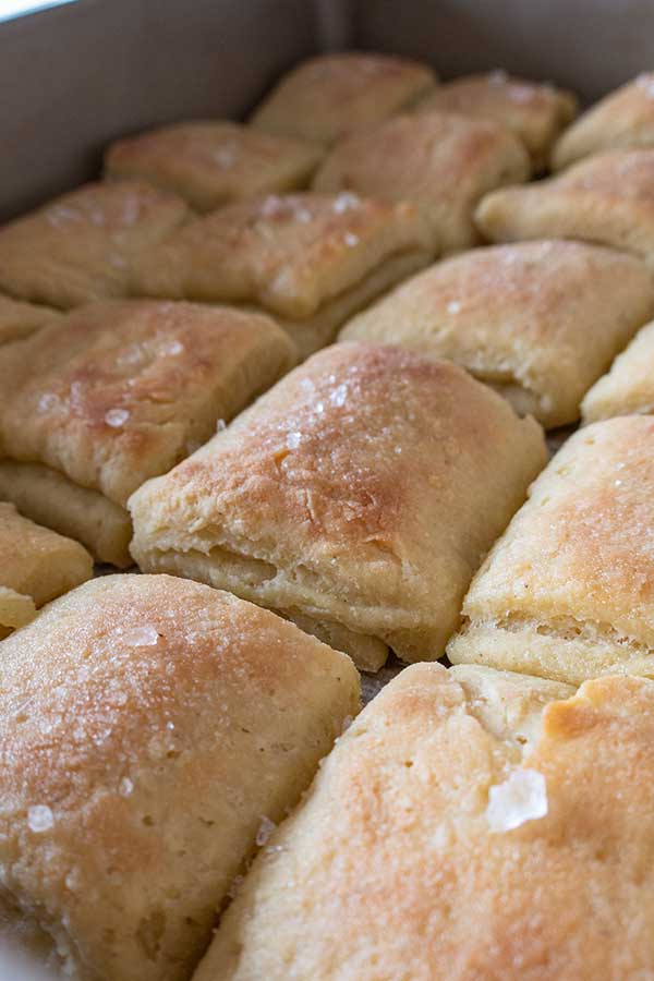 baked rolls brushed with butter and dusted with flaky salt in a pan