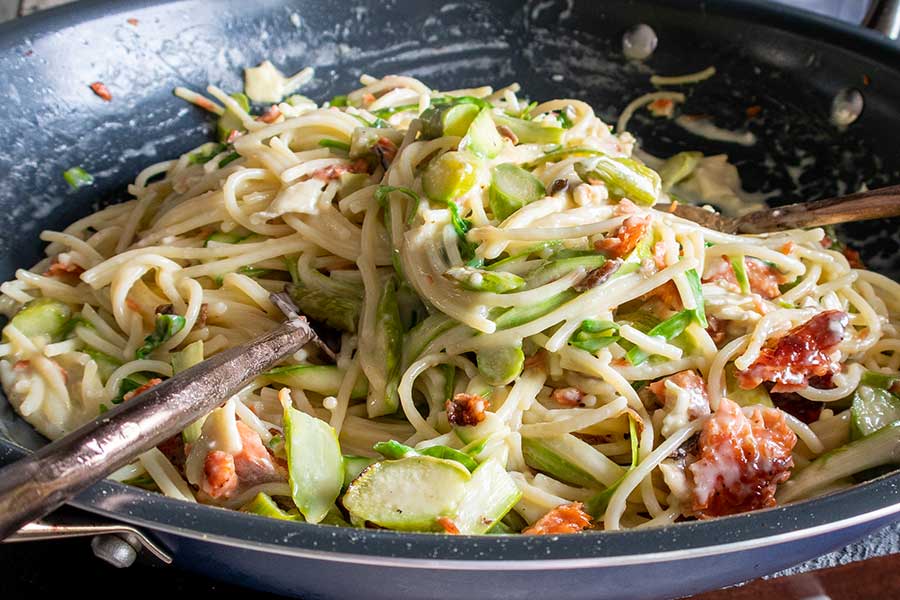salmon and asparagus pasta in a skillet, gluten free
