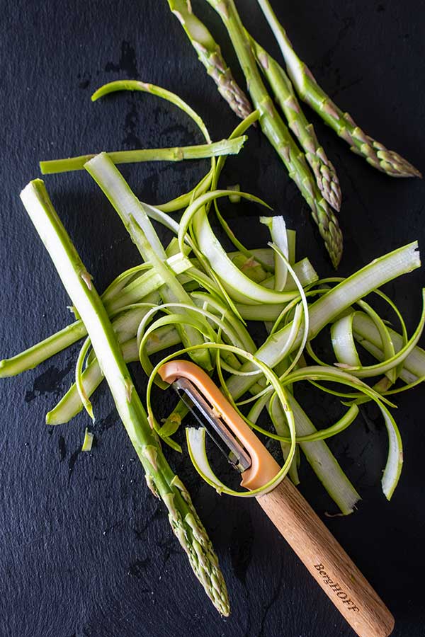 shaved asparagus spears on black tray