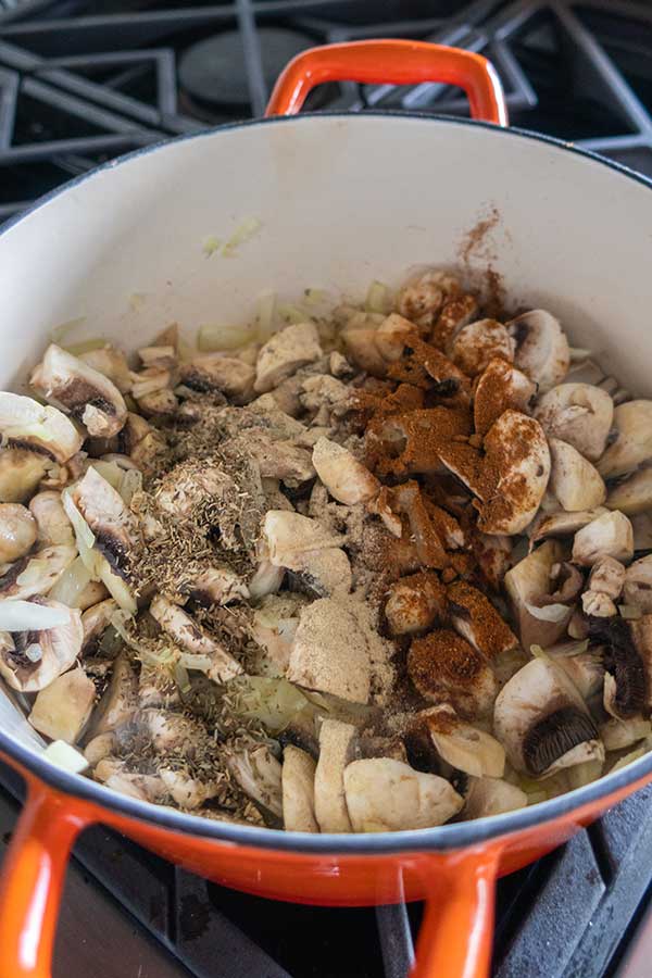 onions, mushrooms, turkey and spices in a pot