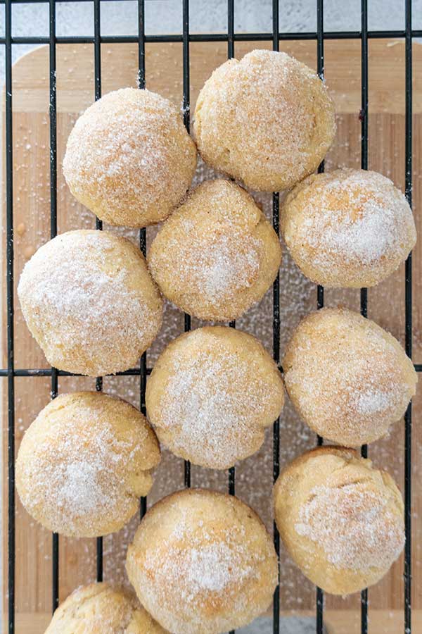 baked donuts rolled in sugar on a rack