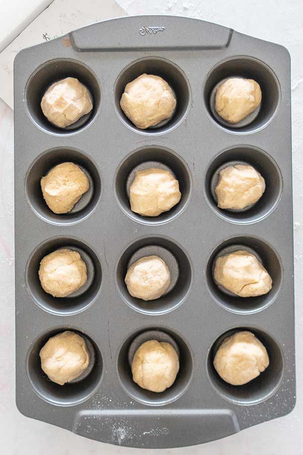 balls of donut dough in a muffin pan