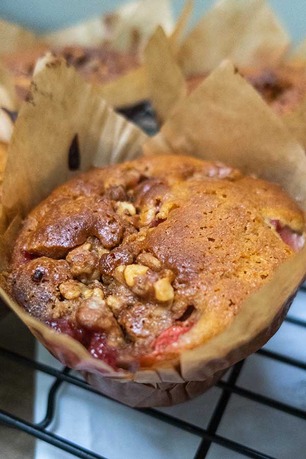 1 gluten free strawberry muffin with pecans in a muffin pan