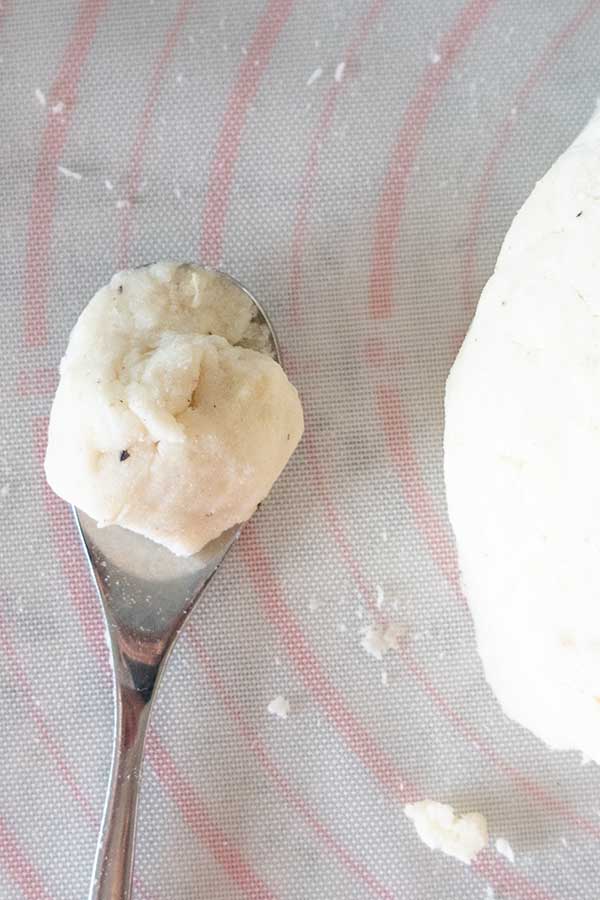 gnocchi dough in a teaspoon
