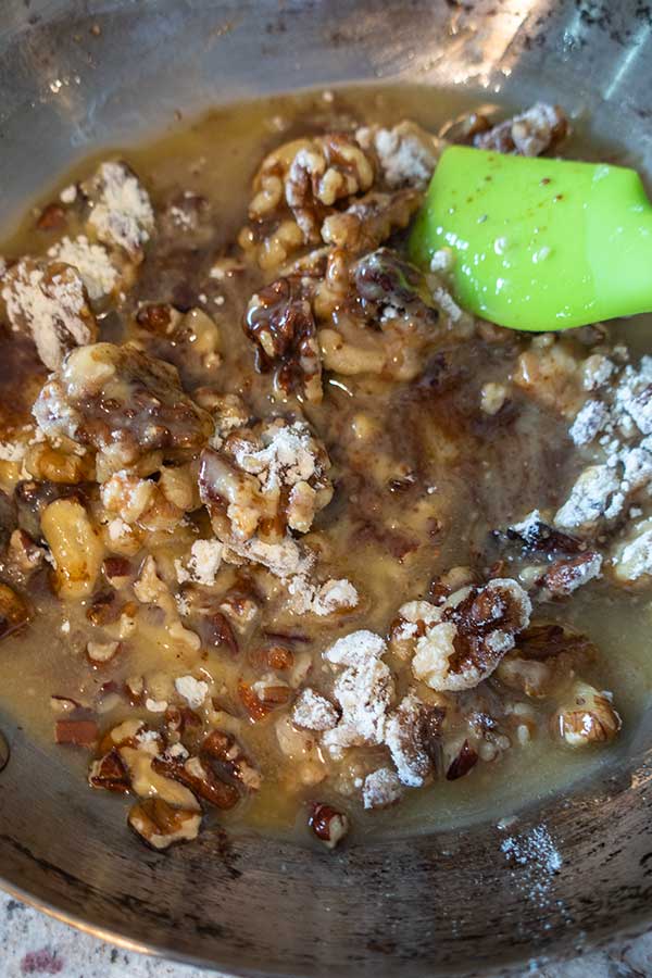 pecans, coconut oil, flour and sugar in a skillet