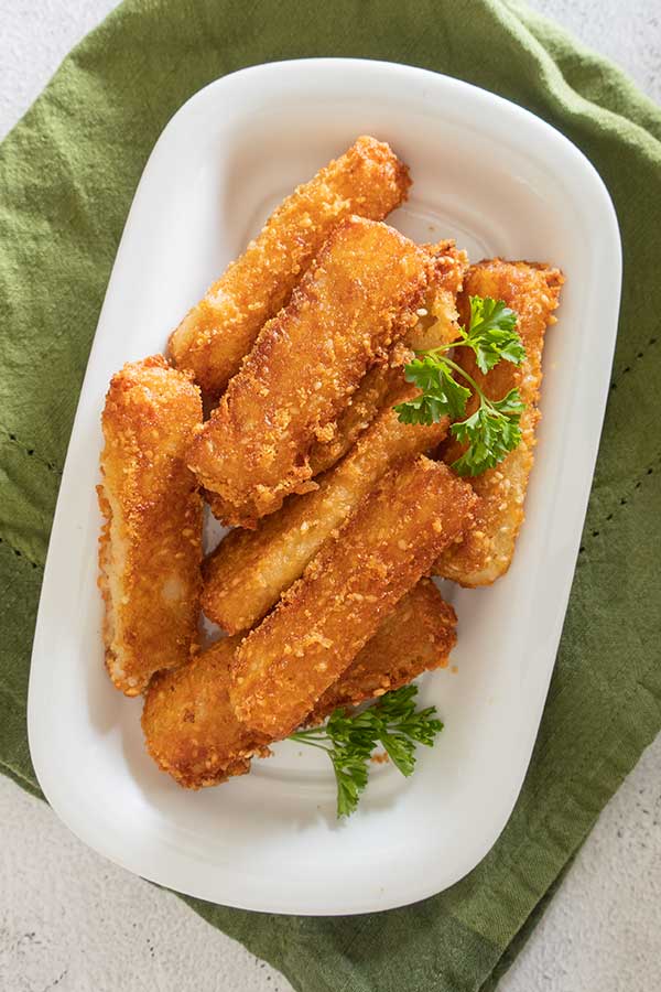 gluten free potato sesame cheese sticks on a plate with parsley