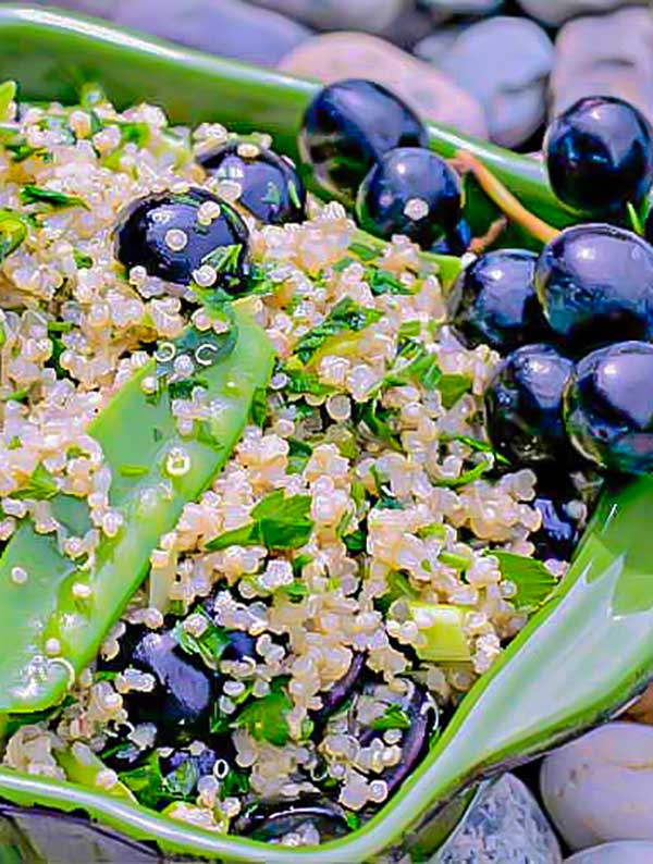  quinoa snow peas and grapes salad in a green bowl