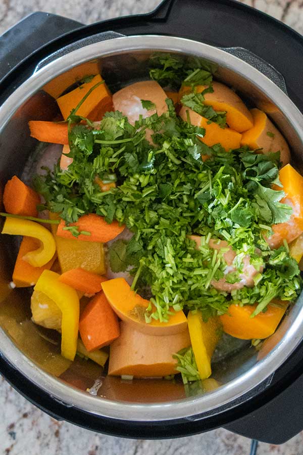 whole raw chicken and vegetables in instant pot before cooking