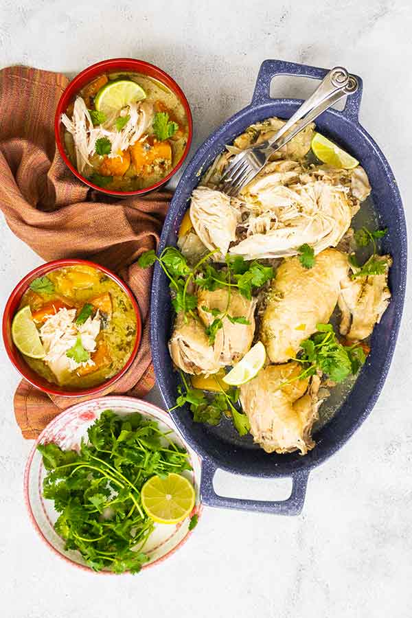 thai green chicken soup in bowls and whole chicken on a platter