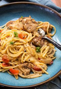 cajun chicken pasta on a plate with a fork