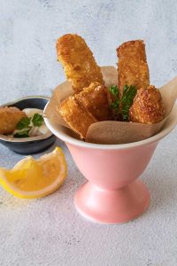 potato cheese sesame sticks in a pink cup