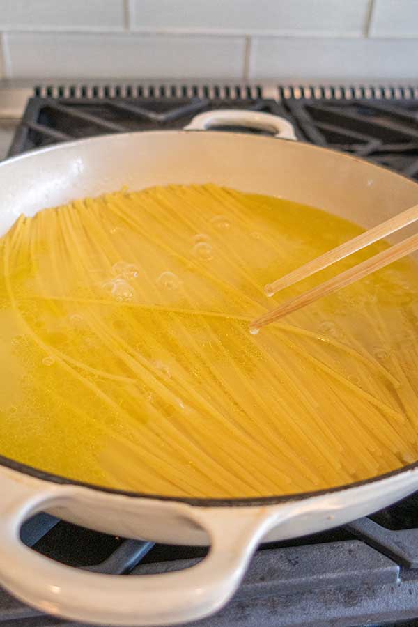 spaghetti cooking in shallow water