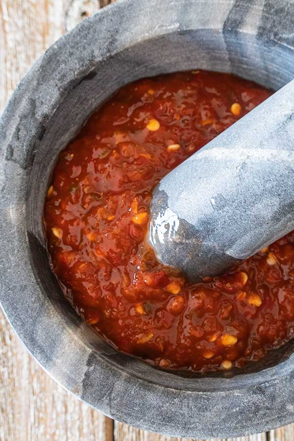 hot chilli paste in a mortar with a pestle