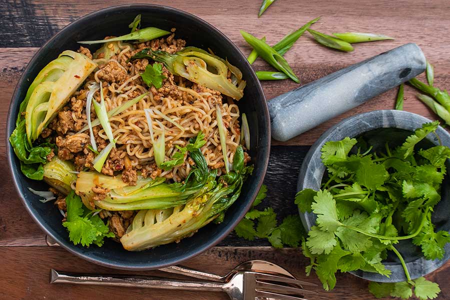 pork and bok choy saucy noodles in a bowl