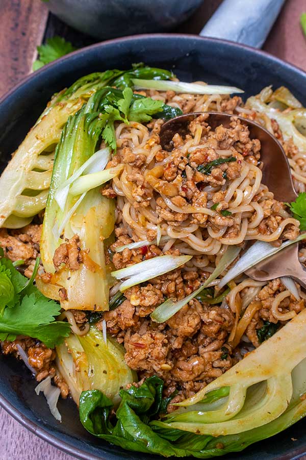 close up gluten-free sambal pork noodles in a bowl