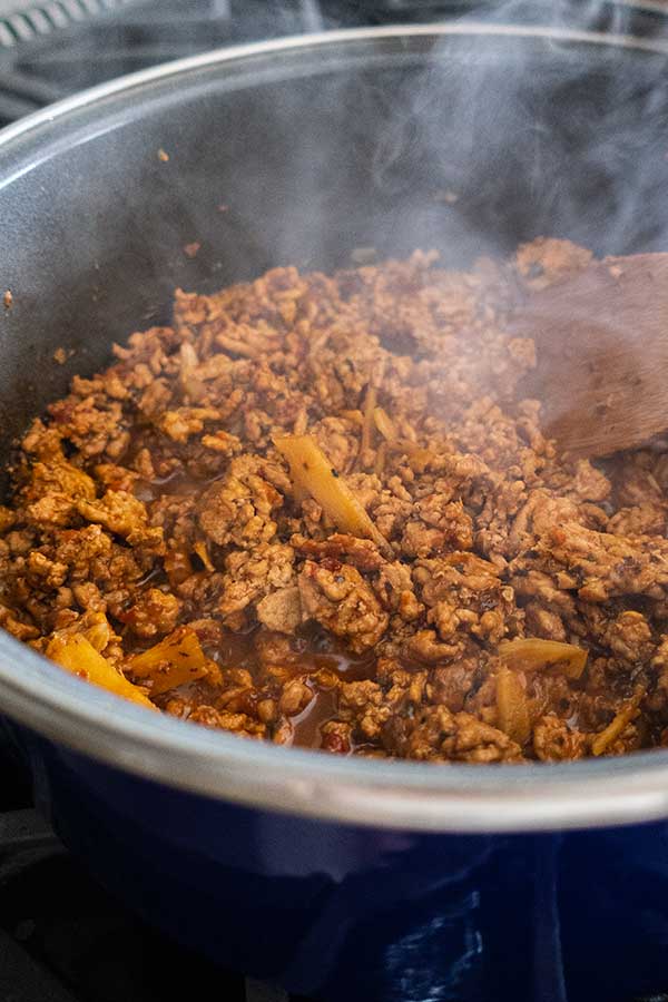 sambal pork simmering in a saucepan