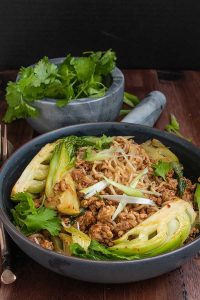 sambal pork with ramen and bok choy in a skillet