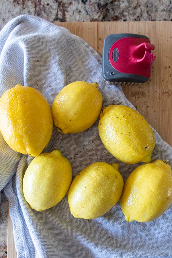 lemons on a towel and vegetable brush