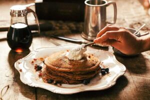 30 minute recipes, pancakes on a plate with whipped cream.