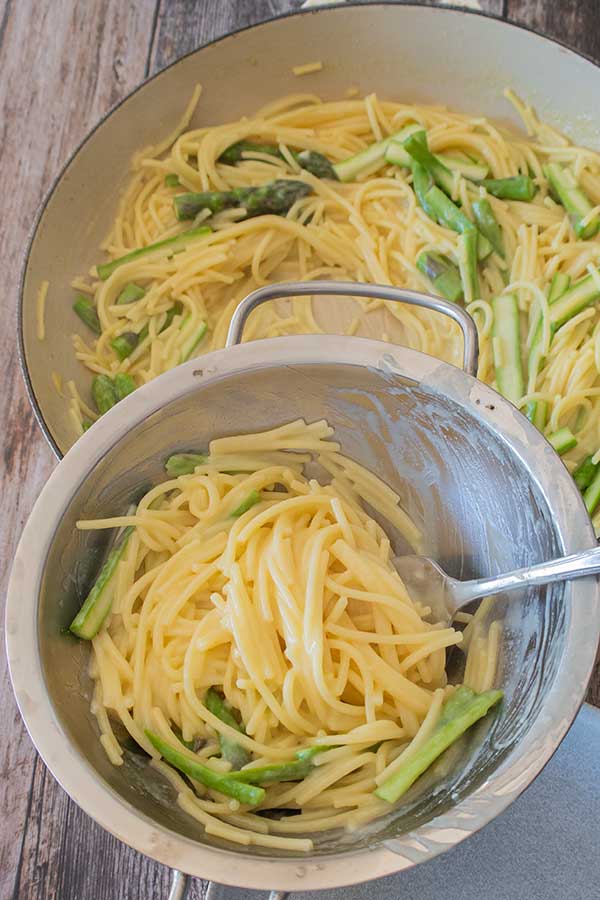 swirling pasta with a fork in a large ladle