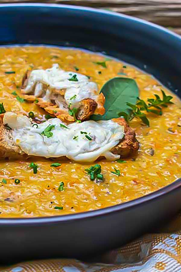 close up roasted vegetable soup in a bowl with crostini