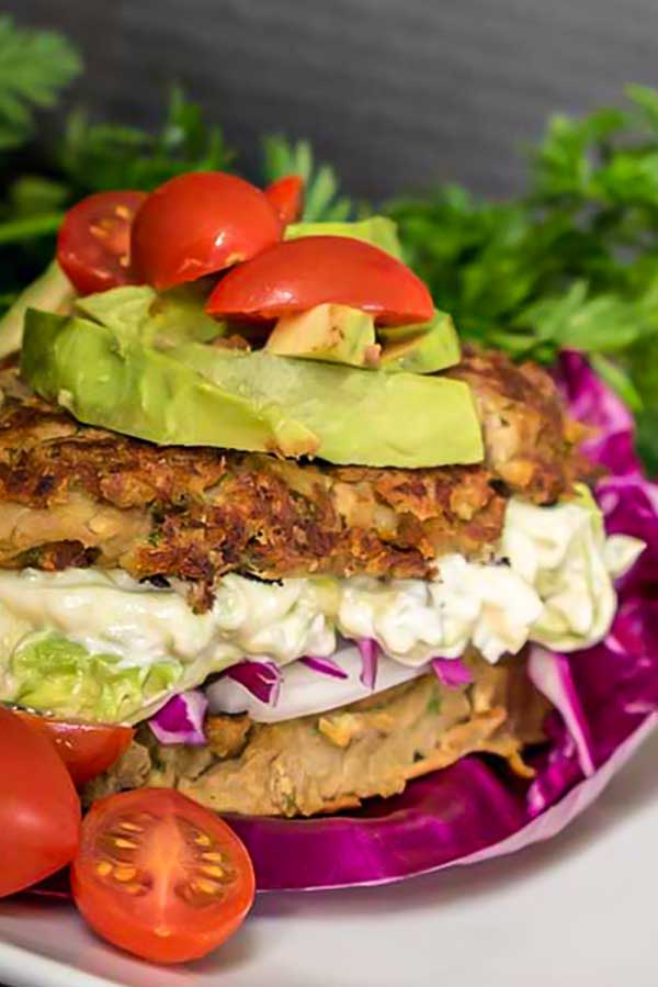 vegan lentil burger with avocado and tomatoes