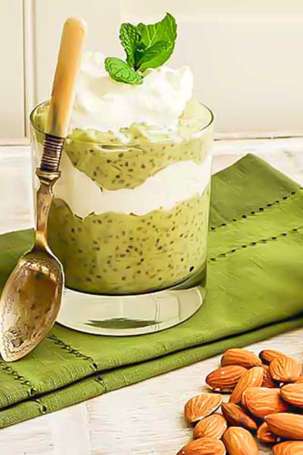 matcha avocado chia pudding in a cup with cream
