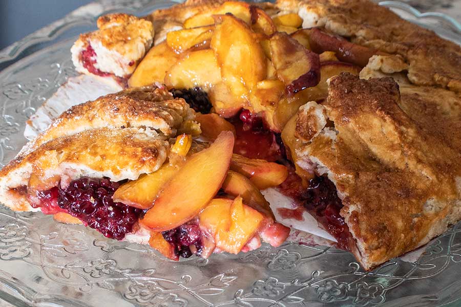 peach and blackberry galettes on a plate showcasing fresh seasonal fruit