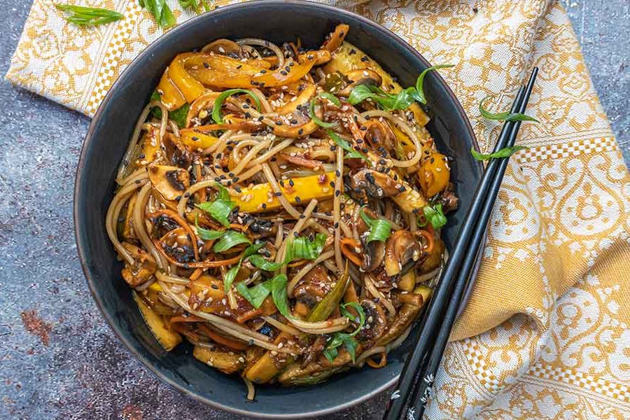 overview of vegan korean noodles in a bowl with chopsticks