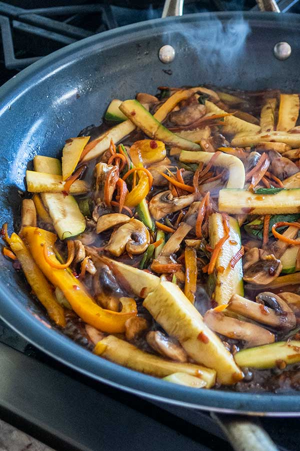 stir-frying veggies in a skillet