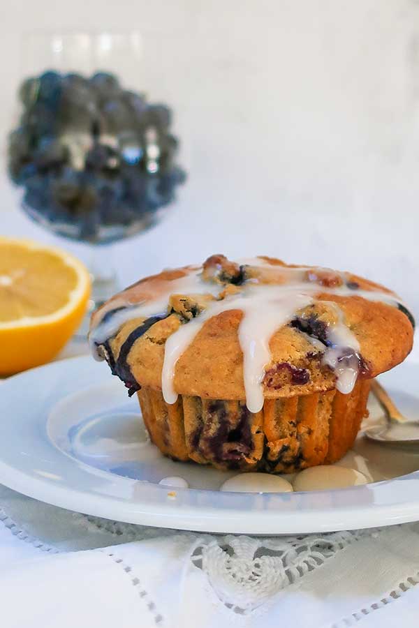 lemon blueberry muffin with icing on a plate, gluten free