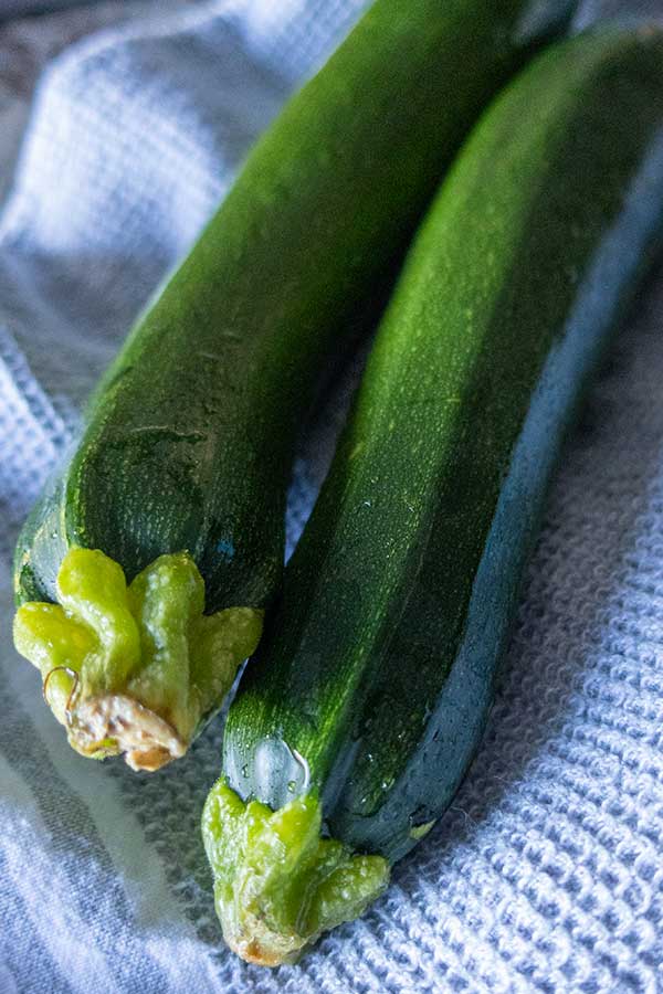 2 zucchini on a towel