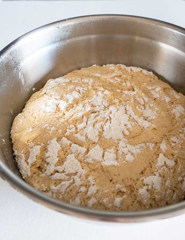 bread dough rising in a bowl