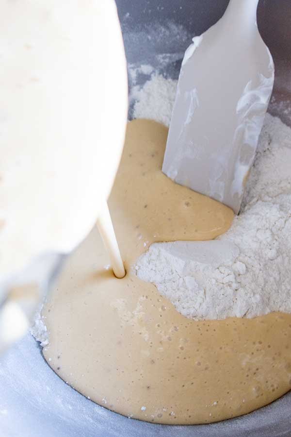 stirring banana cake batter in a bowl