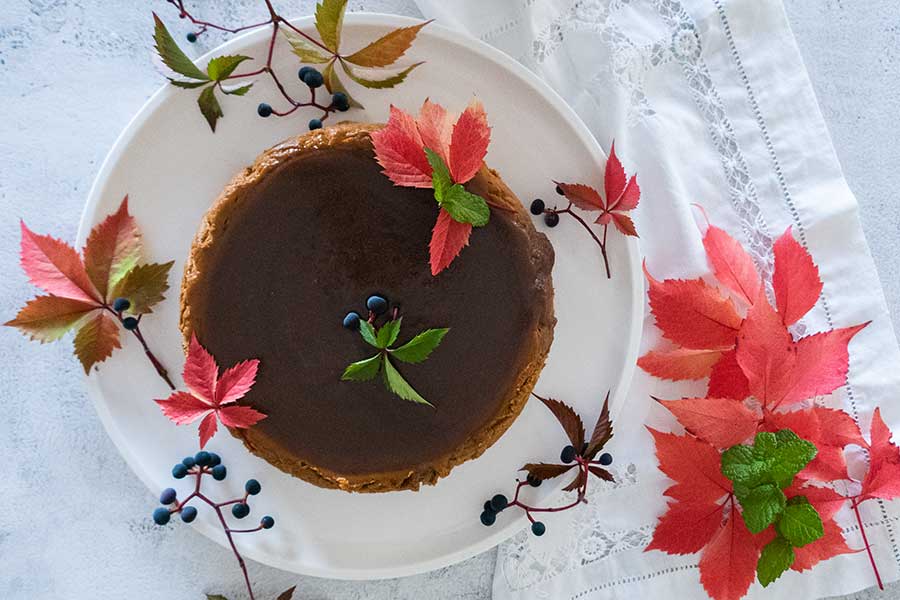 overview of whole chai pumpkin cheesecake decorated with flowers for Easter
