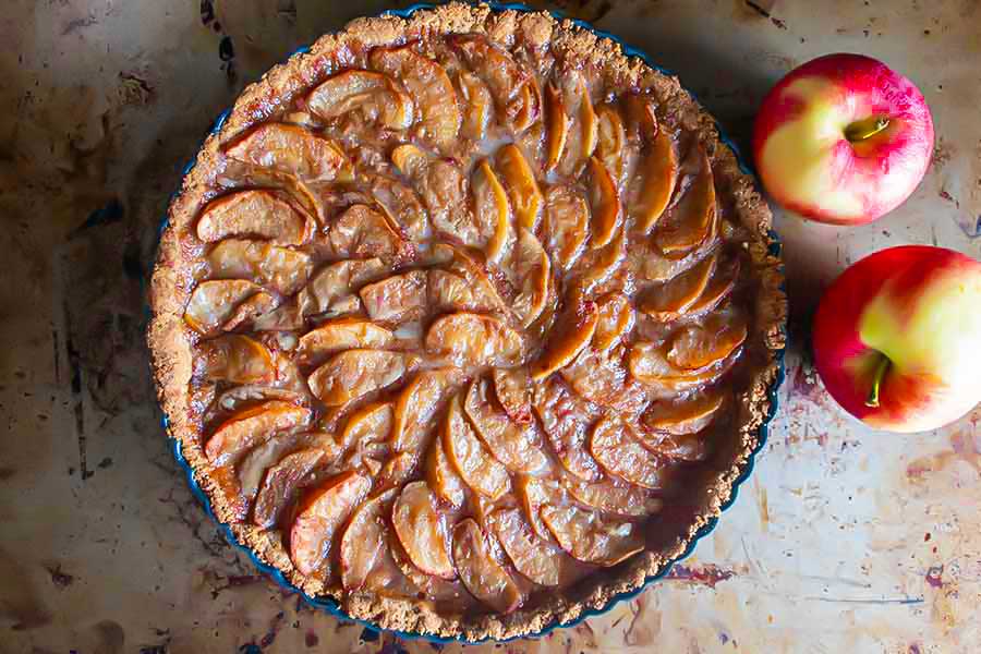 overview of maple caramel apple tart in a tart pan, egg free, gluten. free