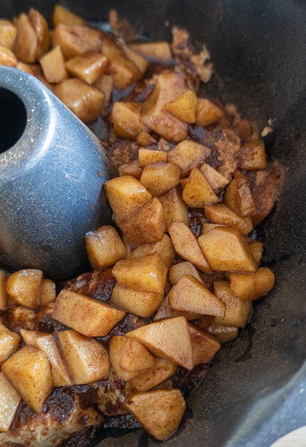 batter with cinnamon apples in a bundt pan